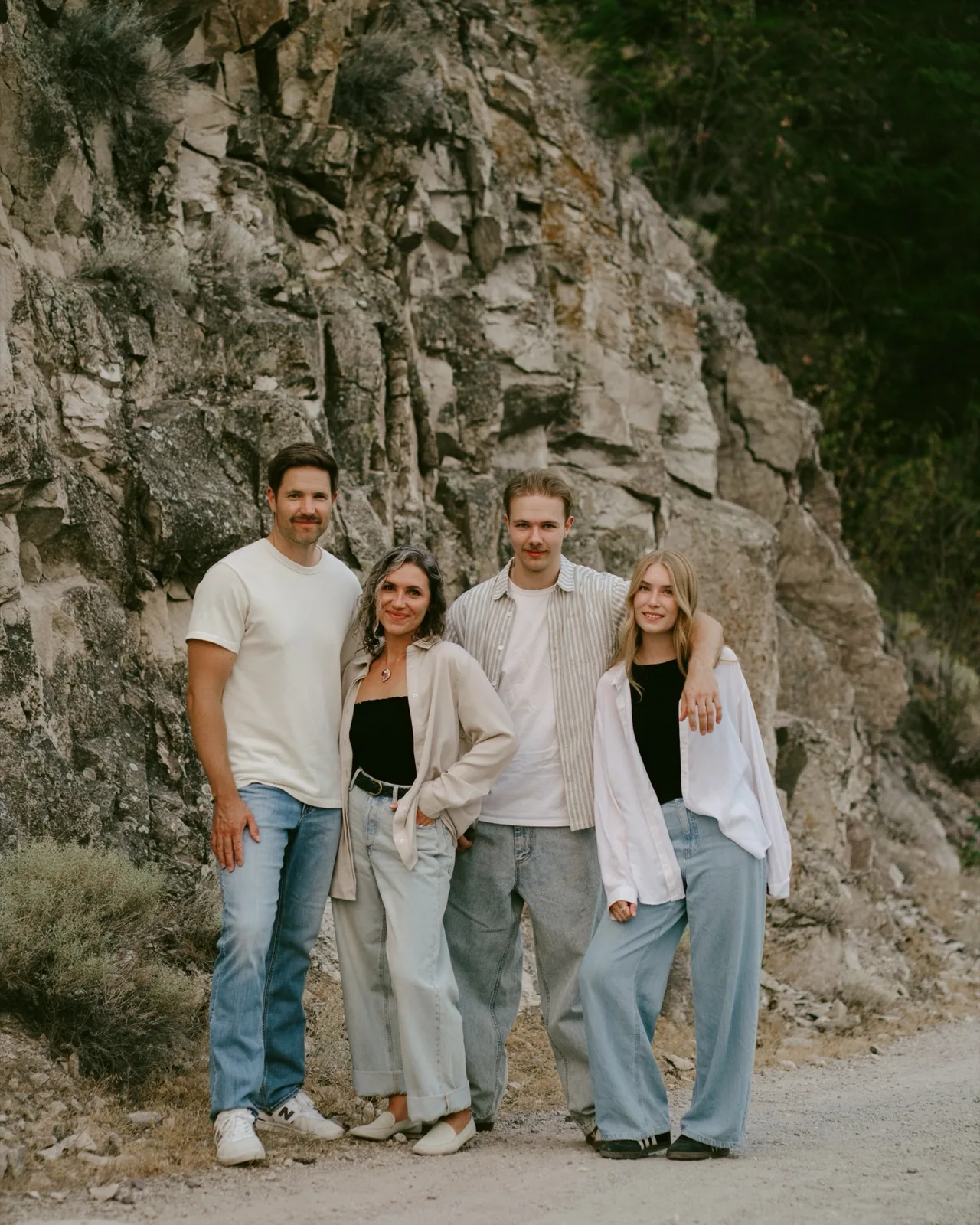 Stephen, Leah and their two children together beside a rock face.